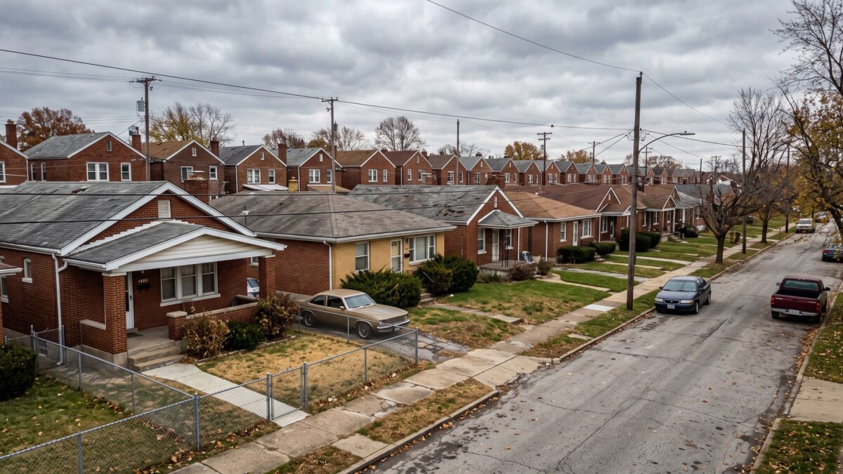 A tight block of 1950s brick bungalows and ranches shoulder to shoulder on narrow lots.